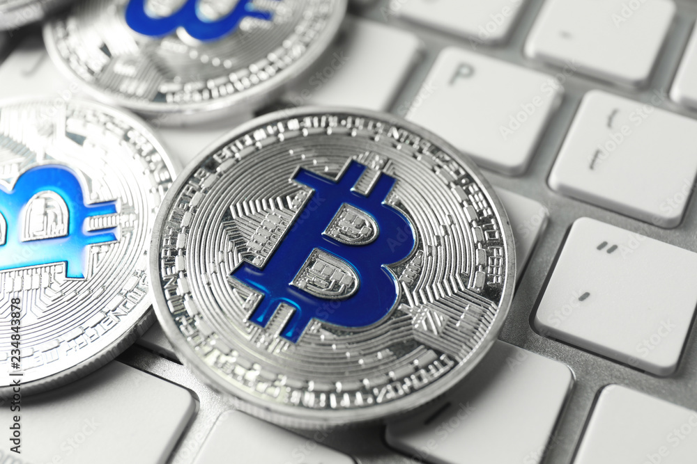 Bitcoins on PC keyboard, closeup