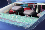 Fototapeta Dmuchawce - Rear windscreen of car smashed up, window broken