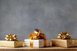 Heap of golden gift or present boxes on wooden table. Composition for birthday or christmas.