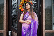 © AS Photo Family - Indian hindu girl at traditional violet saree posed at street against door of restaurant with autumn mood and pumpkins.