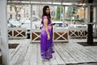 © AS Photo Family - Indian hindu girl at traditional violet saree posed at street against wooden terrace.