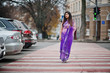 © AS Photo Family - Indian hindu girl at traditional violet saree posed at street , walking at pedestrian crossing.