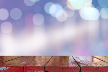 Canvas Print - wooden desk with blurred light bokeh abstract background