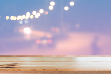 Canvas Print - wooden desk with blurred light bokeh abstract background