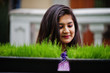 © AS Photo Family - Indian hindu girl at traditional violet saree posed at  street against green grass on pots. Eco concept.