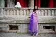 © AS Photo Family - Indian hindu girl at traditional violet saree posed at  street against old house with red curtains.