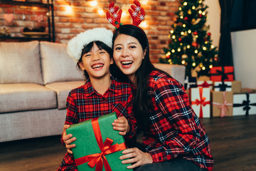 sweet family cheerful hugging in living room