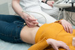 © Aleksey Khripunkov - Closeup of a doctor's hand with ultrasound sensor on woman's stomach in hospital