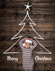 Wall Mural - Merry Christmas greetings in vertical top view dark vintage wood.Happy child girl in homewear and christmas tree pine design.Childhood concept.Xmas winter holiday season social media card background