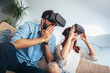 © Mediteraneo - Young man and woman in casual clothes wear the virtual reality glasses are watching and showing imagine via the VR camera, Technology and innovation concept