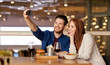 © Syda Productions - leisure, technology and people concept - happy couple having lunch and taking selfie by smartphone at restaurant