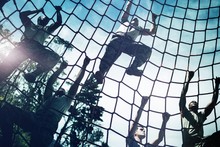 Military Soldiers Climbing Rope During Obstacle Course