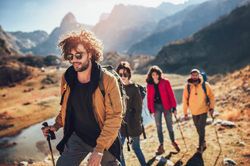 Poster - Group of hikers walking on a mountain at autumn day