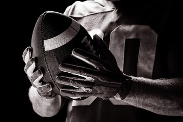 Wall Mural - American football player holding rugby ball