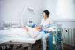 © KONSTANTIN SHISHKIN - Cosmetology clinic. A client taking anti-aging procedure.