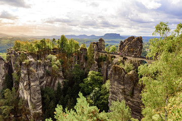  Panorama view on the Bastei bridge. Bastei is famous for the beautiful rock formation in Saxon Switzerland National Park, near Dresden and Rathen - Germany. Popular travel destination in Saxony.