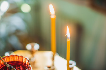 Wall Mural - church candles burn in prayer