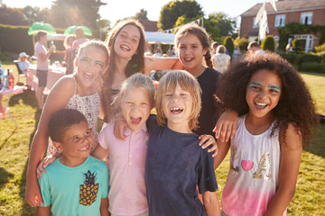portrait of excited children at summer garden fete