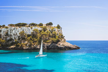 Beautiful Bay With Sailing Boat Yacht, Cala Galdana, Menorca Island, Spain. Yachting, Travel And Active Lifestyle Concept