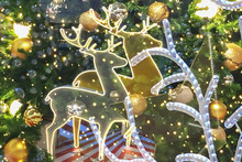 Christmas Golden Reindeer  Festive Holiday Interior Atmosphere With Golden Shiny Ball And Christmas Tree Background.