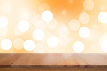 Wall Mural - Wooden desk with Gradient Abstract Blurred orange tone lights background