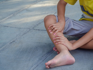 Kid boy feel knee pain after play. healthy problem concept.