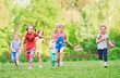 © davit85 - Many different kids, boys and girls running in the park on sunny summer day in casual clothes