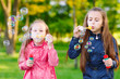 © davit85 - Girls play with soap bubbles.