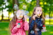 © davit85 - Girls play with soap bubbles.