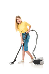 beautiful young woman using vacuum cleaner and smiling at camera isolated on white