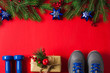 Christmas sport composition dumbbells sneakers branches concept healthy lifestyle