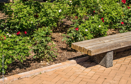 Brown Bark Mulch Covering Flower Bed With Pink Roses In Public