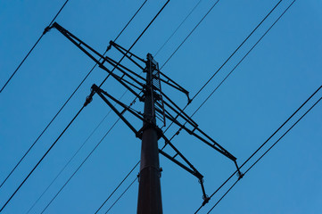  pillar high-voltage power lines against the evening blue sky