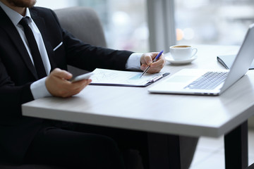 Wall Mural - closeup.businessman checking financial statement,sitting at the Desk