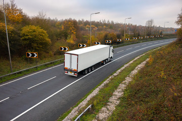 Wall Mural - Road transport. Articulated lorry in motion on the road