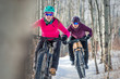 Two Women riding Fat Bikes in the Snow