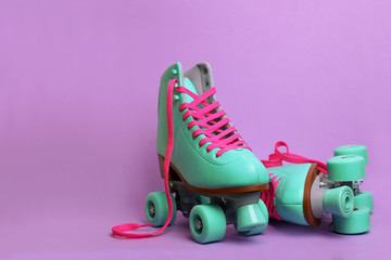 Wall Mural - pair of stylish quad roller skates on color background. space for text