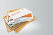 Pile of envelopes with overdue utility bills isolated on white