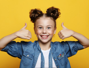 Wall Mural - Portrait of a beautiful and confident girl showing thumbs up 