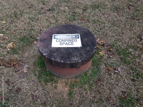 Fotografie, Obraz danger confined space sign on cement hole