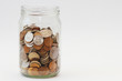 © Tatiana - A pile of coins in a glass jar on white background. Piggy bank with money.