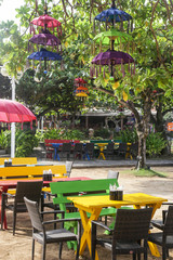 Colorful wooden chairs and tables, outdoor in green area