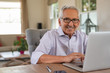 © Rido - Happy smiling old man with laptop