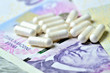 © cobracz - Pills on Czech banknotes - concept of healthcare and finance