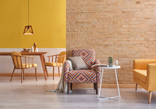 Yellow Room Wooden Furniture And Brick Wall Concept.
