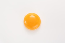 Raw Egg Yolk On A White Background. View From Above.