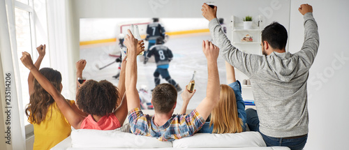 friendship, sport and leisure concept - happy friends drinking beer and watching Wallpaper Mural