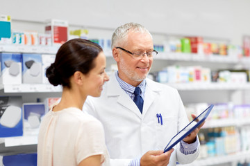 Sticker - medicine, healthcare and technology concept - senior apothecary and female customer with tablet pc computer at pharmacy