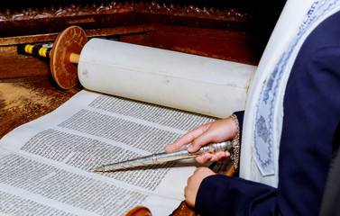 Hand of boy reading the Jewish Torah at Bar Mitzvah Bar Mitzvah Torah reading