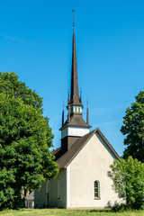 Canvas Print - White church with tall and narrow tower